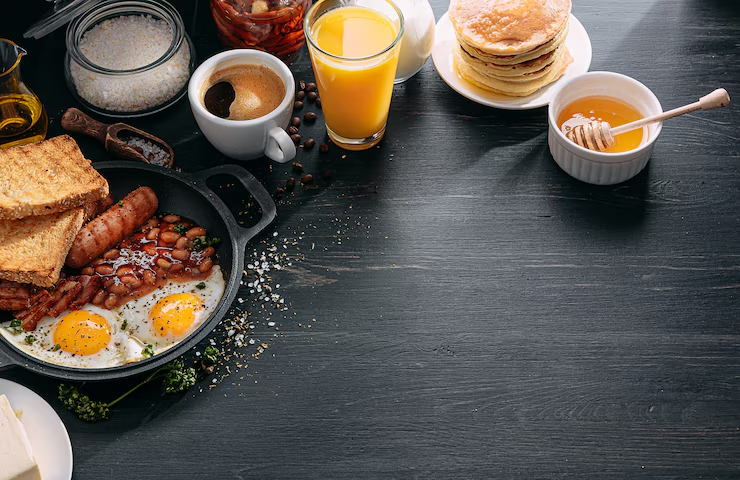 english-breakfast-dark-table-fried-eggs-with-bacon-canned-beans-sausage_152625-2998
